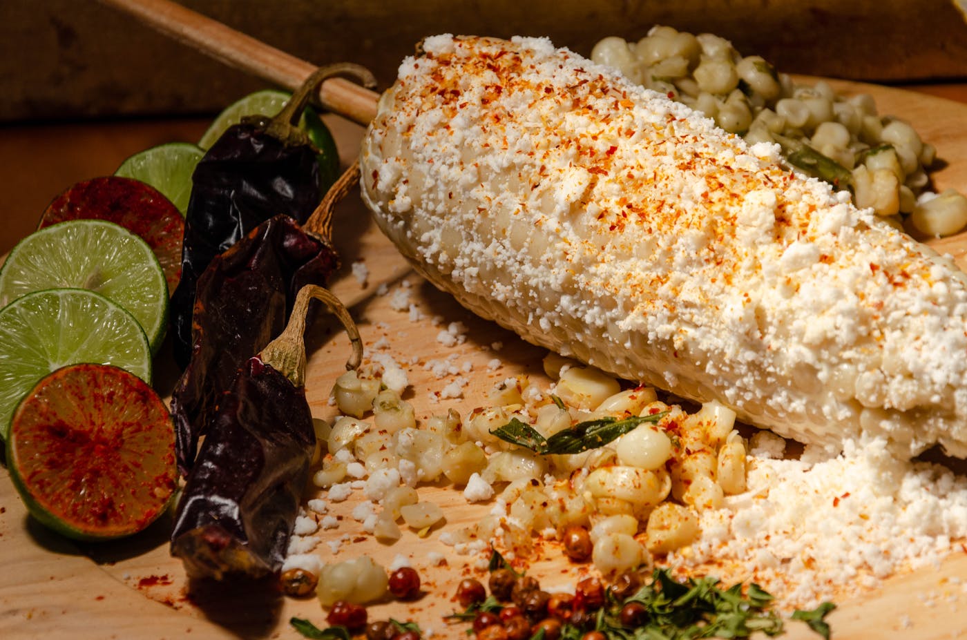 Grilled corn on the cob, charred, brushed with chili and a dark sauce