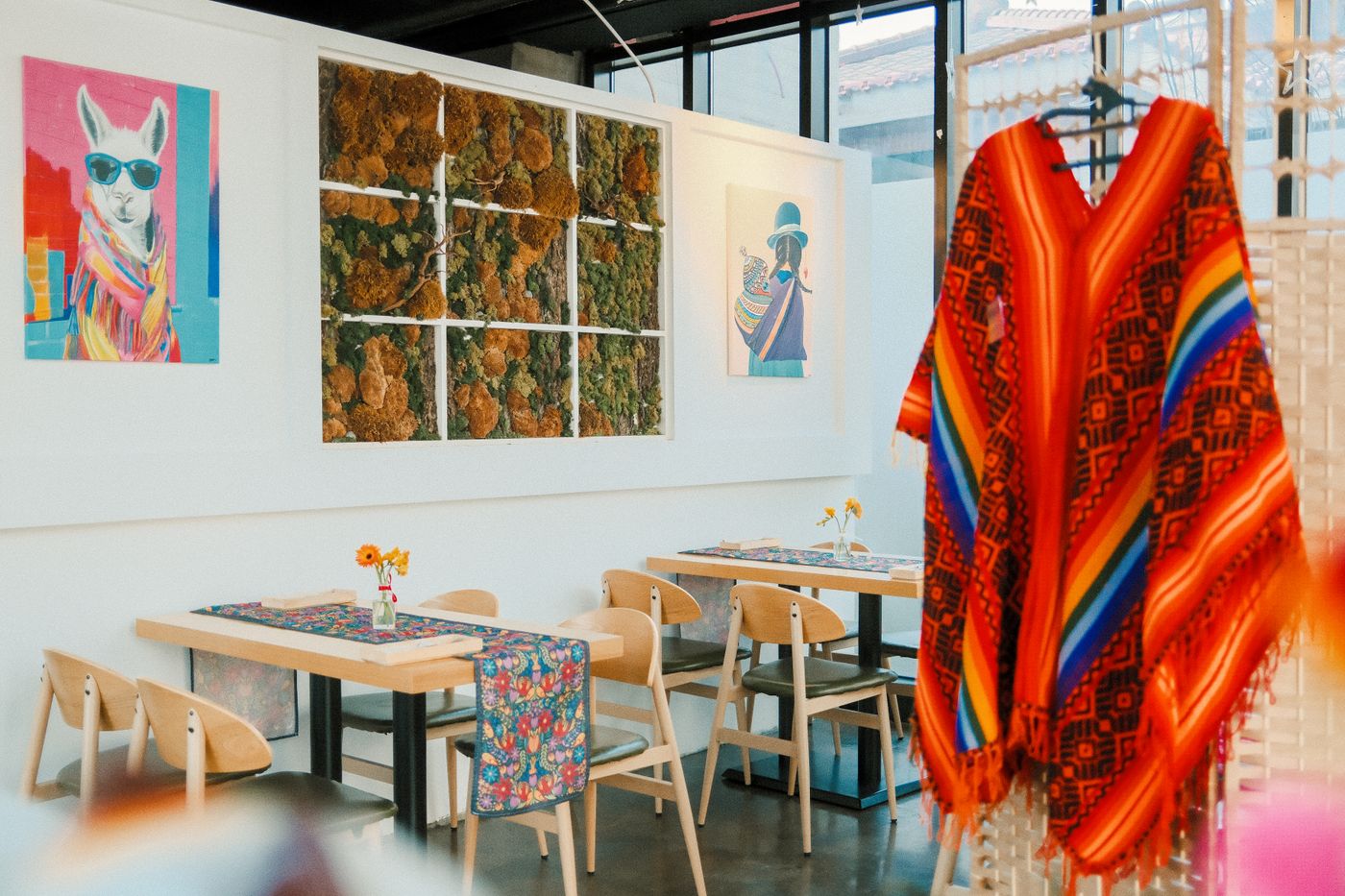 A bright dining room with colorful woven textiles on the chairs
