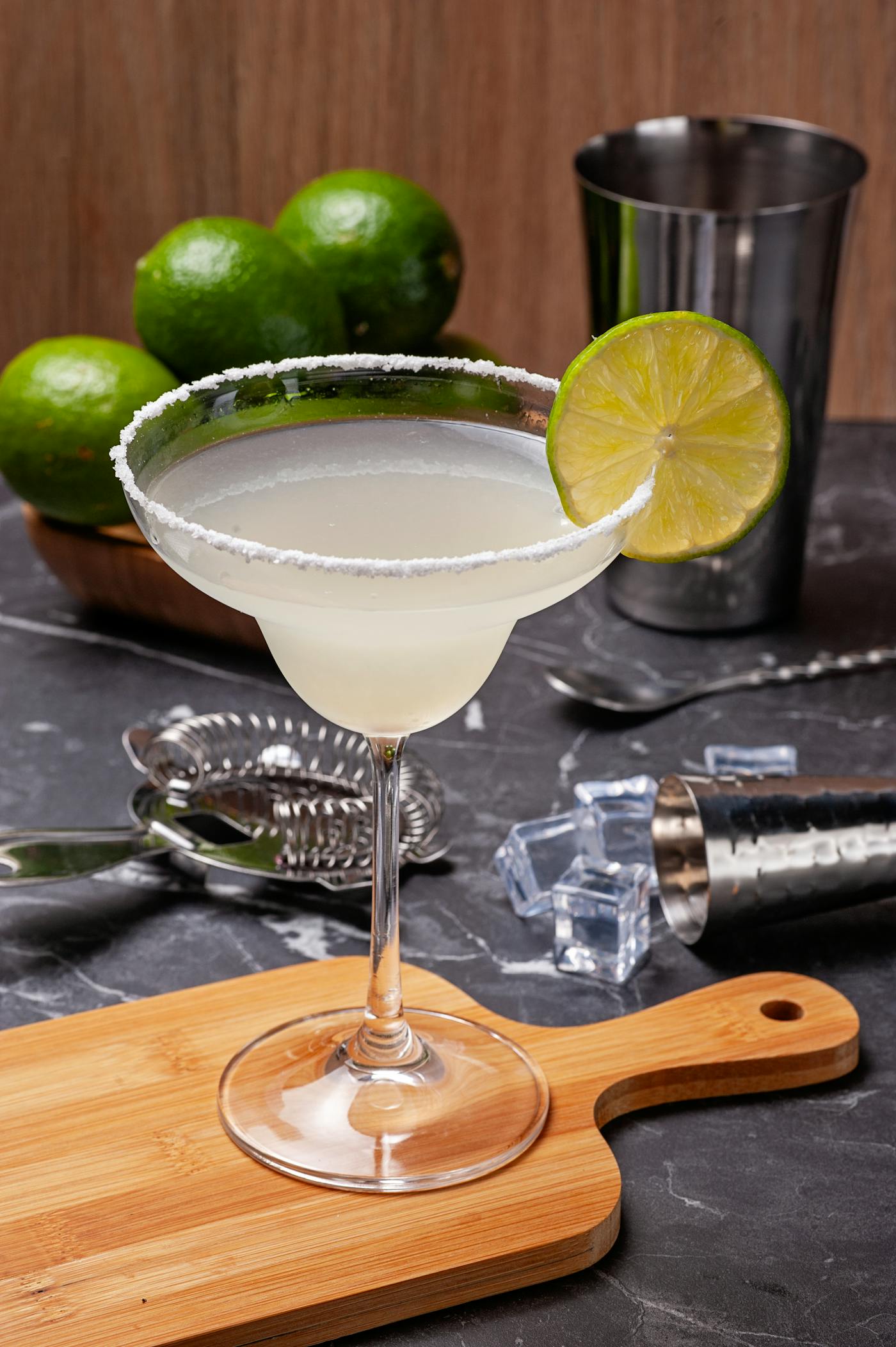A margarita served in a coupe glass with a lime garnish