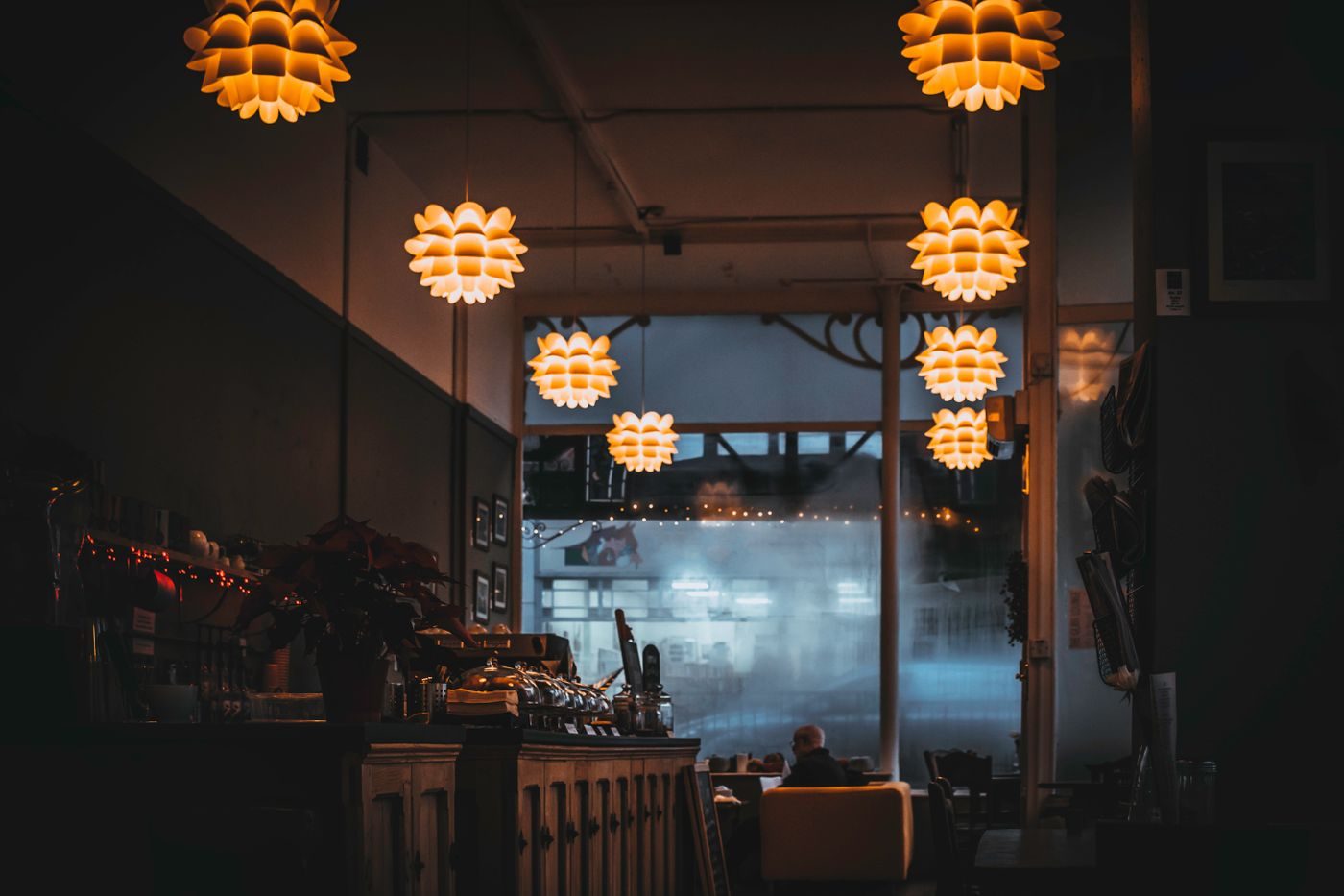 The bright dining room of Stella and Vine, tables set under pendant lights